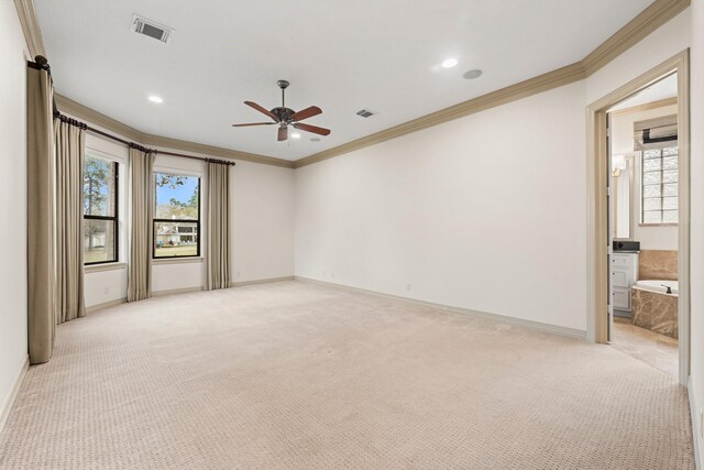 spare room with ceiling fan, light colored carpet, and ornamental molding