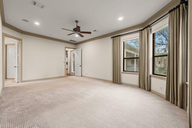 unfurnished room with crown molding, light carpet, and ceiling fan