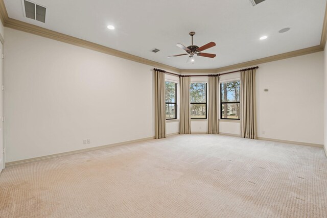 unfurnished room with light carpet, crown molding, and ceiling fan