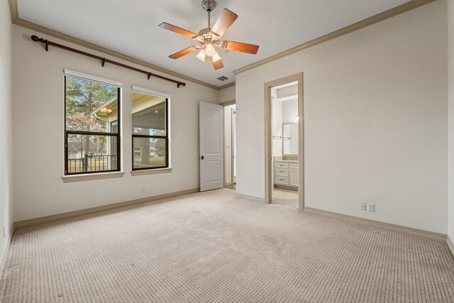 unfurnished bedroom featuring ceiling fan, ornamental molding, connected bathroom, and light carpet