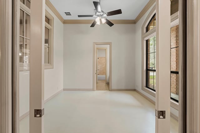 spare room with crown molding, ceiling fan, and plenty of natural light