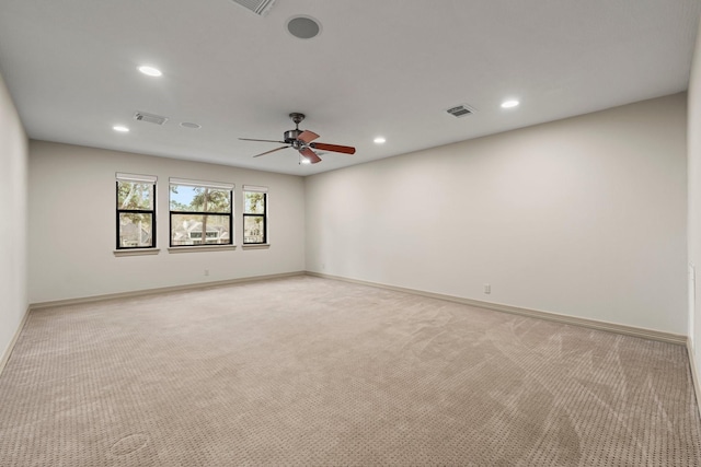 empty room with ceiling fan and light carpet