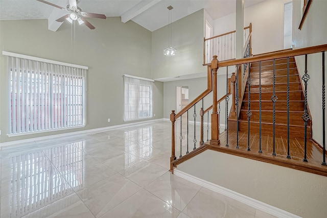 stairway featuring lofted ceiling with beams, tile patterned floors, and ceiling fan