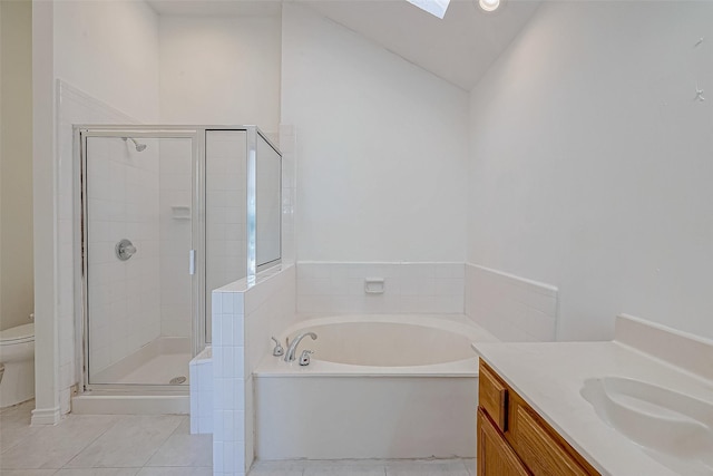 full bathroom with vaulted ceiling with skylight, separate shower and tub, vanity, tile patterned floors, and toilet