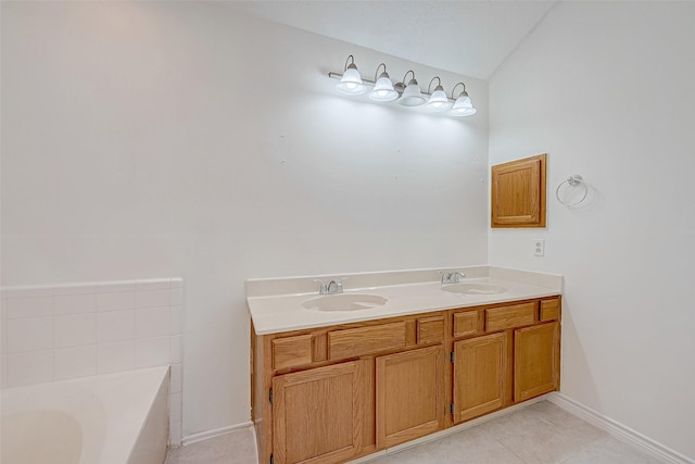 bathroom with vanity, tile patterned flooring, and a bathtub