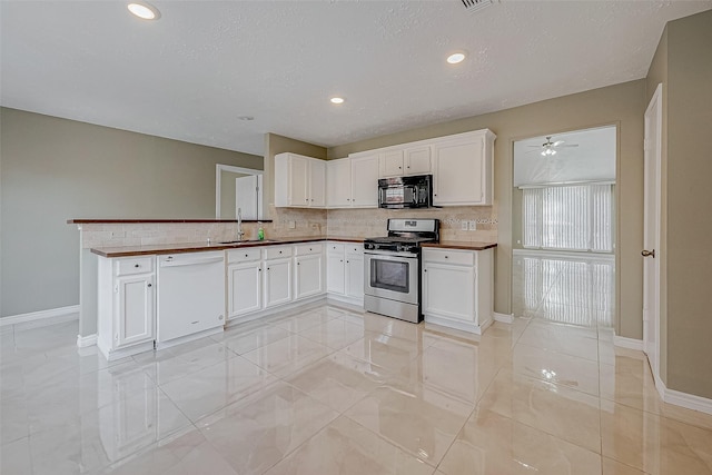 kitchen with white cabinets, white dishwasher, sink, and stainless steel gas stove