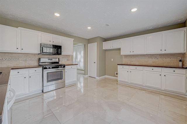 kitchen with gas range and white cabinets