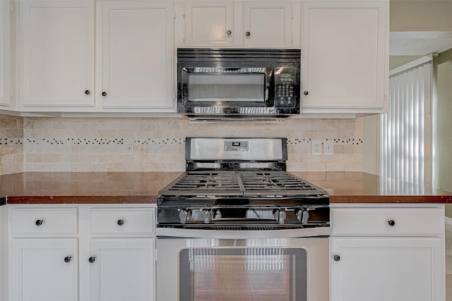 kitchen with white cabinets, decorative backsplash, and stainless steel gas stove