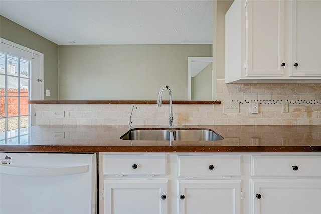 kitchen with white cabinetry, sink, backsplash, and dishwasher