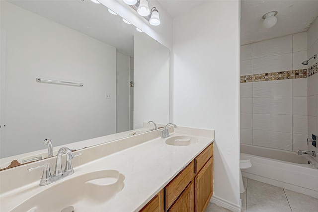 full bathroom featuring vanity, toilet, tiled shower / bath combo, and tile patterned flooring