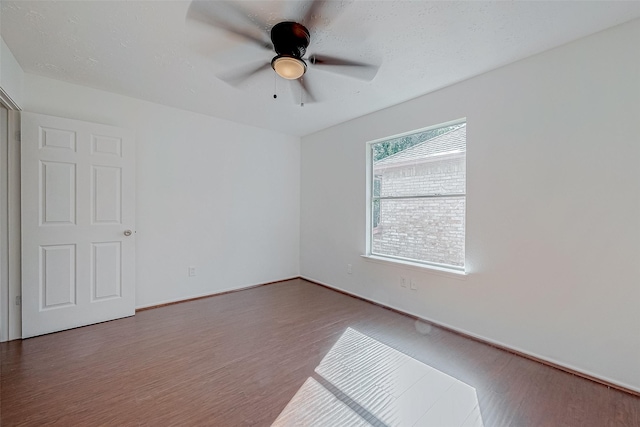 spare room with hardwood / wood-style floors and ceiling fan