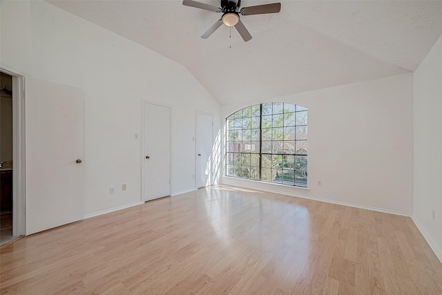 unfurnished living room with ceiling fan, vaulted ceiling, a textured ceiling, and light wood-type flooring