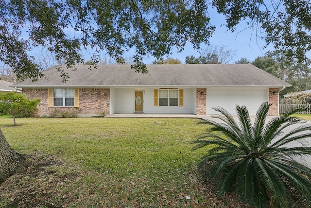 single story home featuring a garage and a front yard