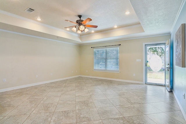 empty room featuring light tile patterned floors, ceiling fan, a raised ceiling, crown molding, and a textured ceiling