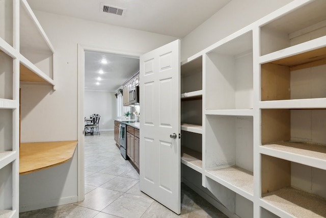 spacious closet featuring light tile patterned floors