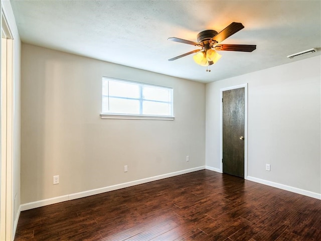 unfurnished room with dark wood-type flooring and ceiling fan