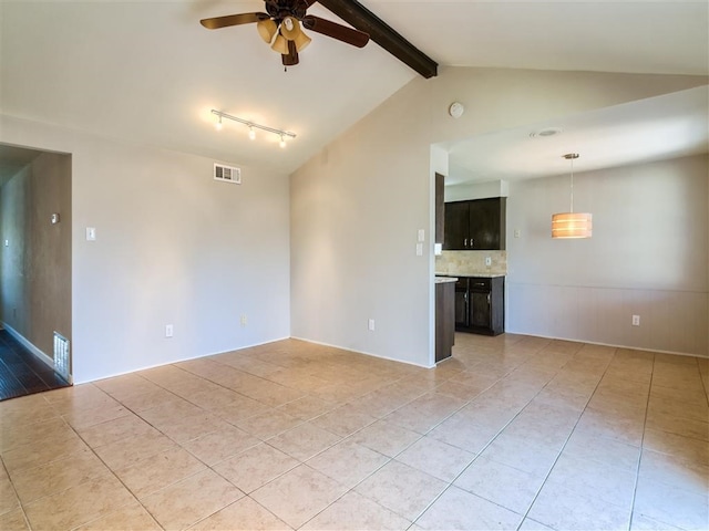 unfurnished living room with lofted ceiling with beams, light tile patterned flooring, and ceiling fan