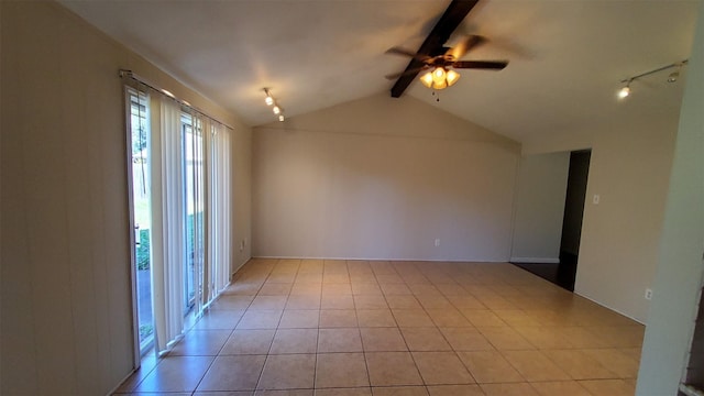 empty room featuring vaulted ceiling with beams, track lighting, ceiling fan, and light tile patterned flooring