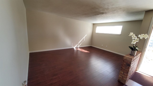 spare room with dark hardwood / wood-style floors and a textured ceiling