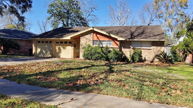 single story home featuring a garage and a front lawn