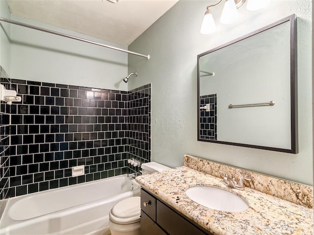 full bathroom with tiled shower / bath combo, vanity, and toilet