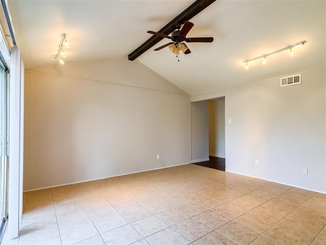 spare room with ceiling fan, rail lighting, lofted ceiling with beams, and light tile patterned floors