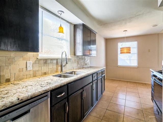 kitchen with gas stove, sink, dark brown cabinets, stainless steel dishwasher, and pendant lighting