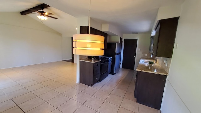 kitchen featuring light tile patterned flooring, stainless steel refrigerator, ceiling fan, dark brown cabinets, and black range with gas cooktop