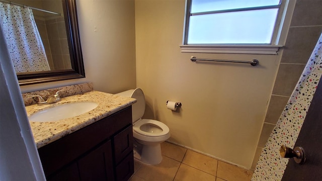 bathroom featuring a shower with shower curtain, vanity, toilet, and tile patterned flooring