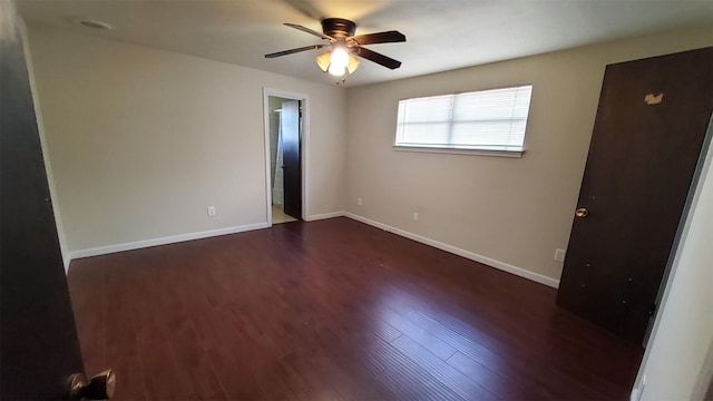 spare room featuring dark hardwood / wood-style floors and ceiling fan