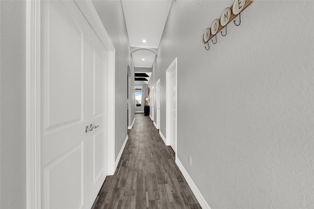 hallway with dark wood-style flooring, recessed lighting, and baseboards