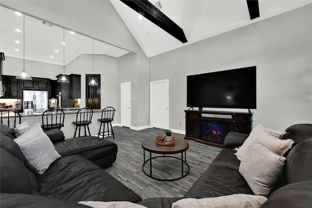 living area featuring a warm lit fireplace, baseboards, dark wood finished floors, beamed ceiling, and high vaulted ceiling