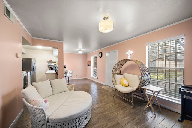 living room with crown molding, plenty of natural light, and dark hardwood / wood-style floors