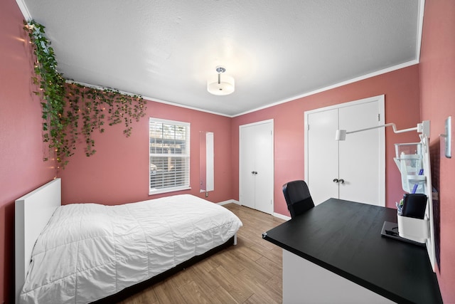 bedroom with crown molding and light hardwood / wood-style floors