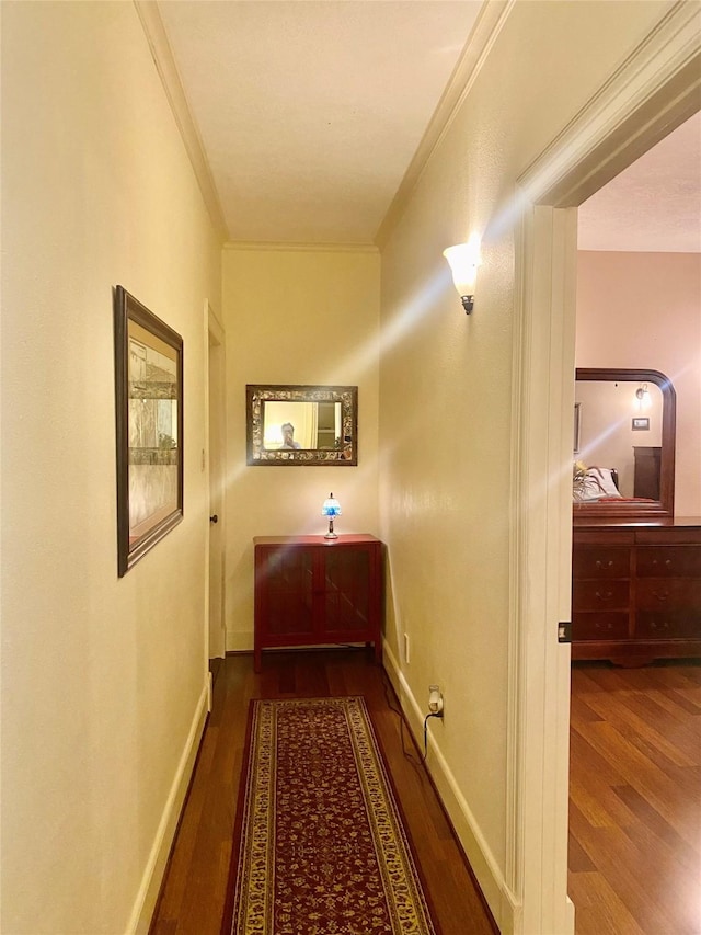 corridor with crown molding and dark wood-type flooring