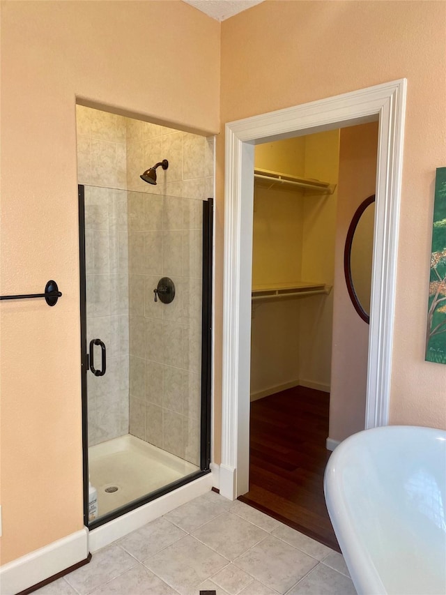 bathroom featuring a shower with door and tile patterned flooring