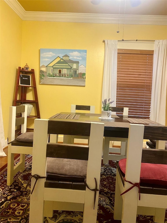 dining area featuring crown molding