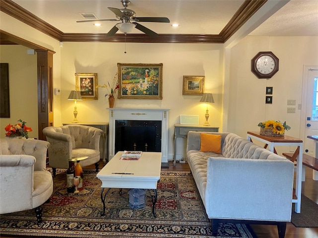 living room featuring crown molding, dark wood-type flooring, and ceiling fan