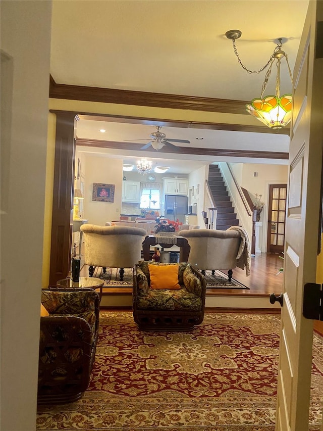 living room featuring ornamental molding and ceiling fan