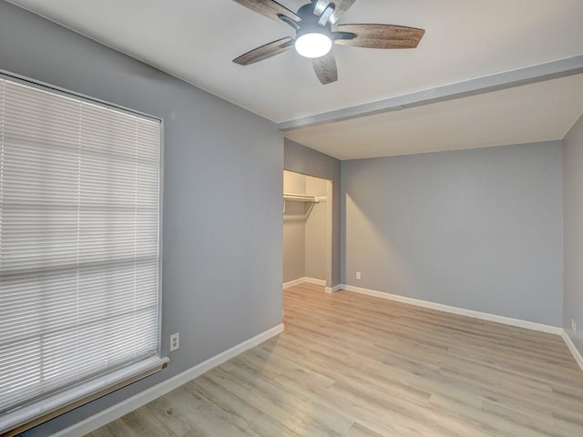 empty room with ceiling fan and light wood-type flooring