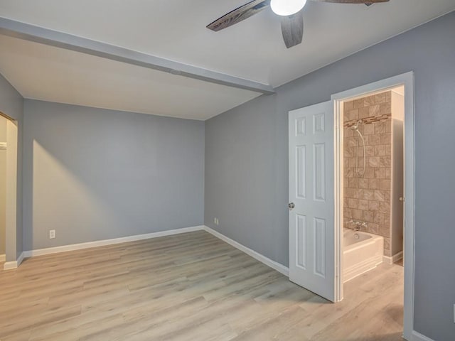 unfurnished bedroom with ceiling fan, light wood-type flooring, and ensuite bath