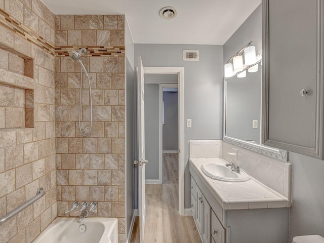 bathroom with vanity, separate shower and tub, and hardwood / wood-style floors