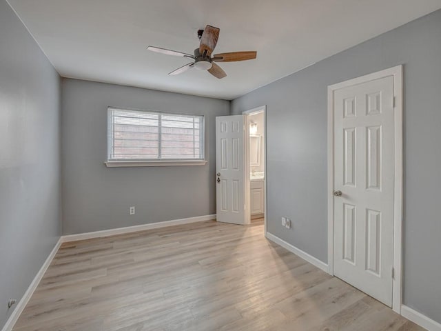 unfurnished bedroom with connected bathroom, ceiling fan, and light wood-type flooring