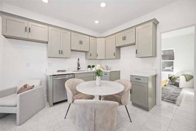 kitchen featuring gray cabinetry, sink, and dishwasher