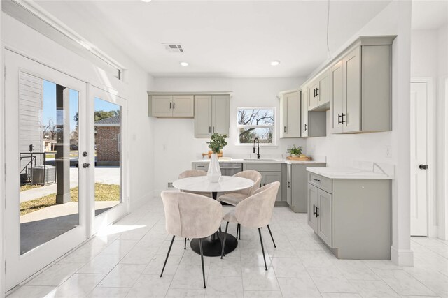 dining room with sink, a wealth of natural light, and french doors