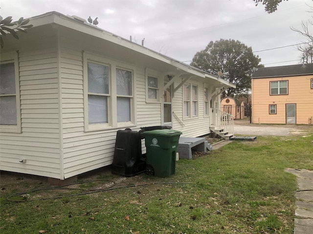 view of side of home with a lawn