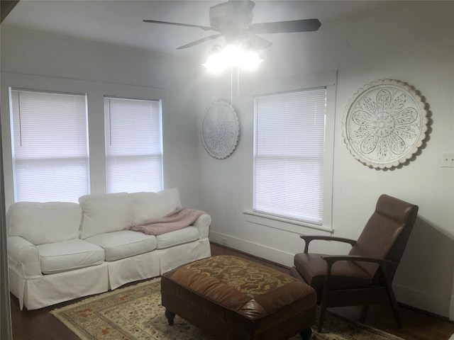 living room with ceiling fan and dark hardwood / wood-style flooring