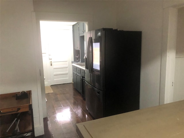 kitchen featuring dark wood-type flooring and refrigerator