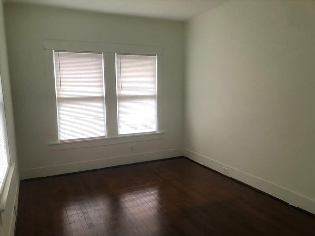 spare room featuring dark wood-type flooring