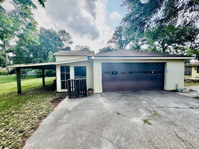 garage with a carport and a lawn